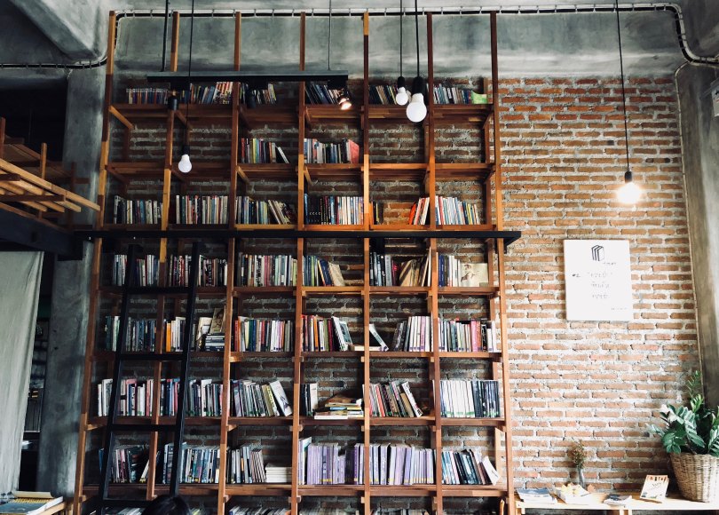 Bookshelf with brick wall and hanging lights