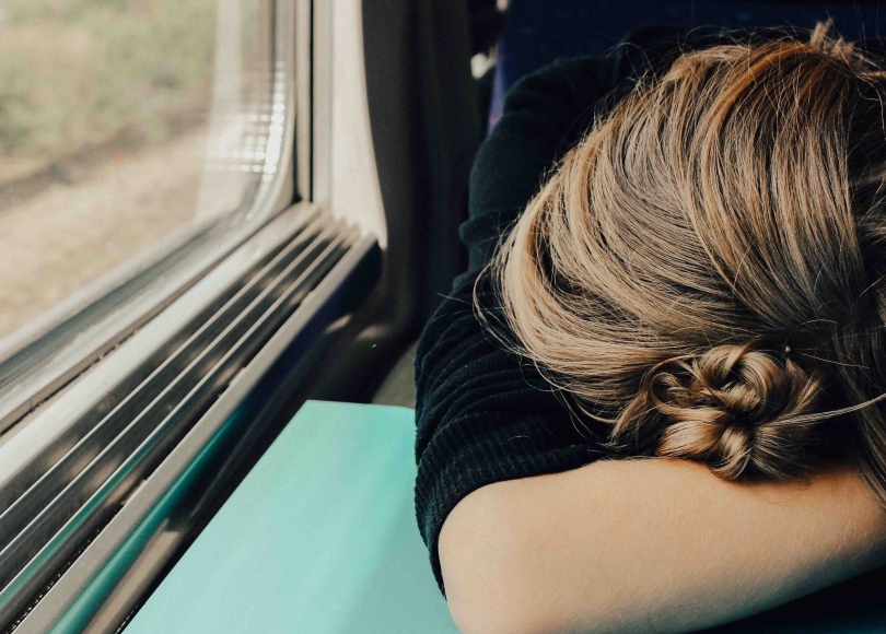 Exhausted woman on a train